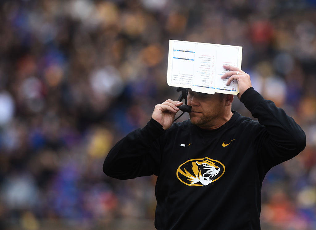 Barry Odom adjusts his headset during the third quarter